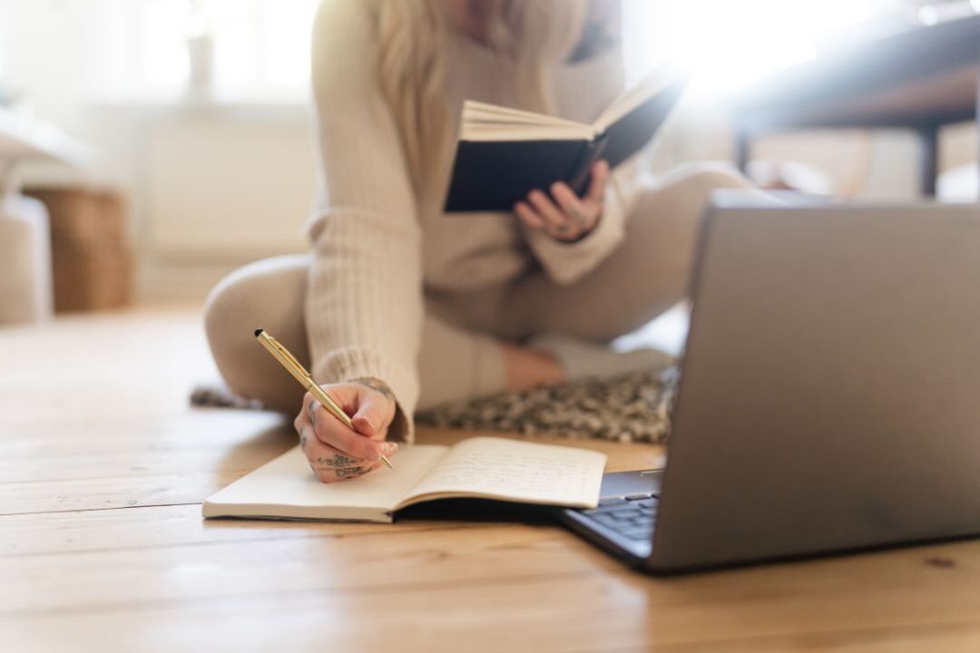 stay at home mom researching finances affirming her financial confidence and independence