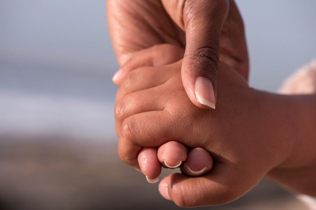 mother and child hands together representing the legacy of love a stay at home mom builds