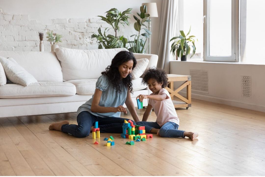 stay at home mom playing on the floor with her children choosing presence over perfection