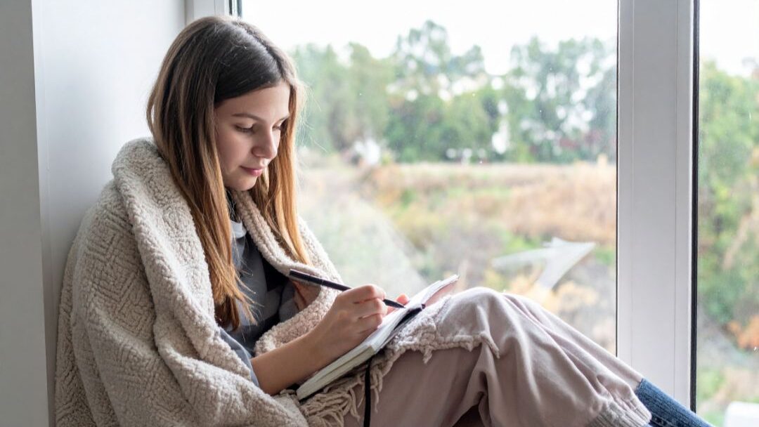 stay at home mom journaling and practicing self forgiveness as part of her positive affirmation practice