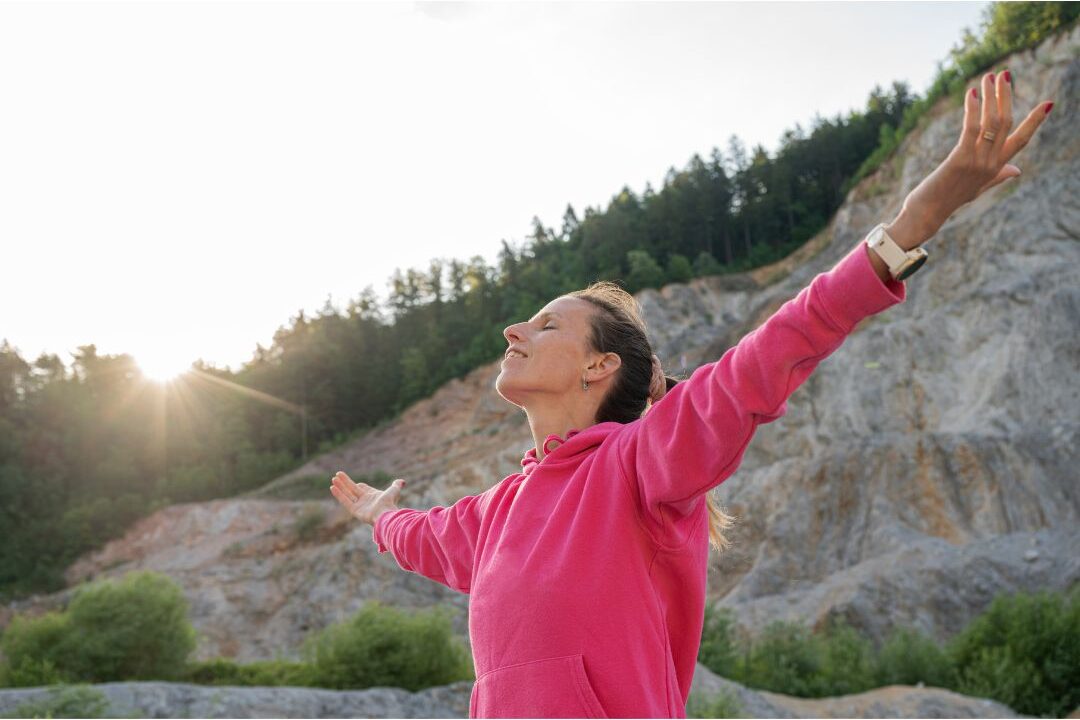 stay at home mom standing with arms open embracing her future self and ongoing growth