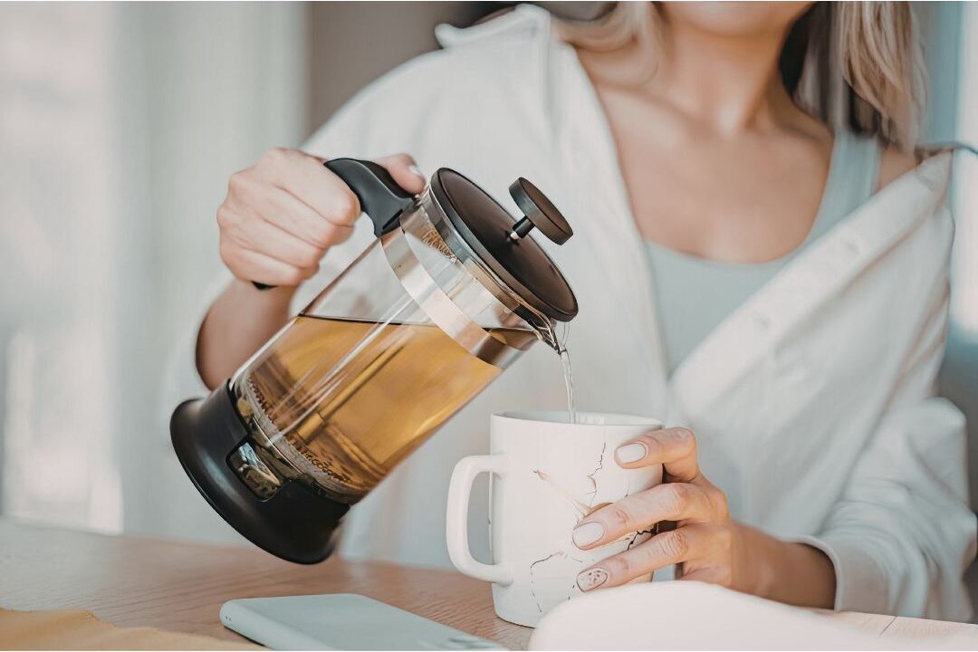 a mother pouring tea in a simple kitchen showing that soft living is accessible