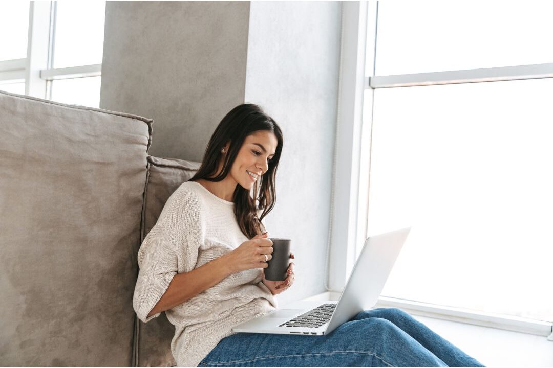 relaxed smiling woman sitting comfortably at home experiencing authentic restoration