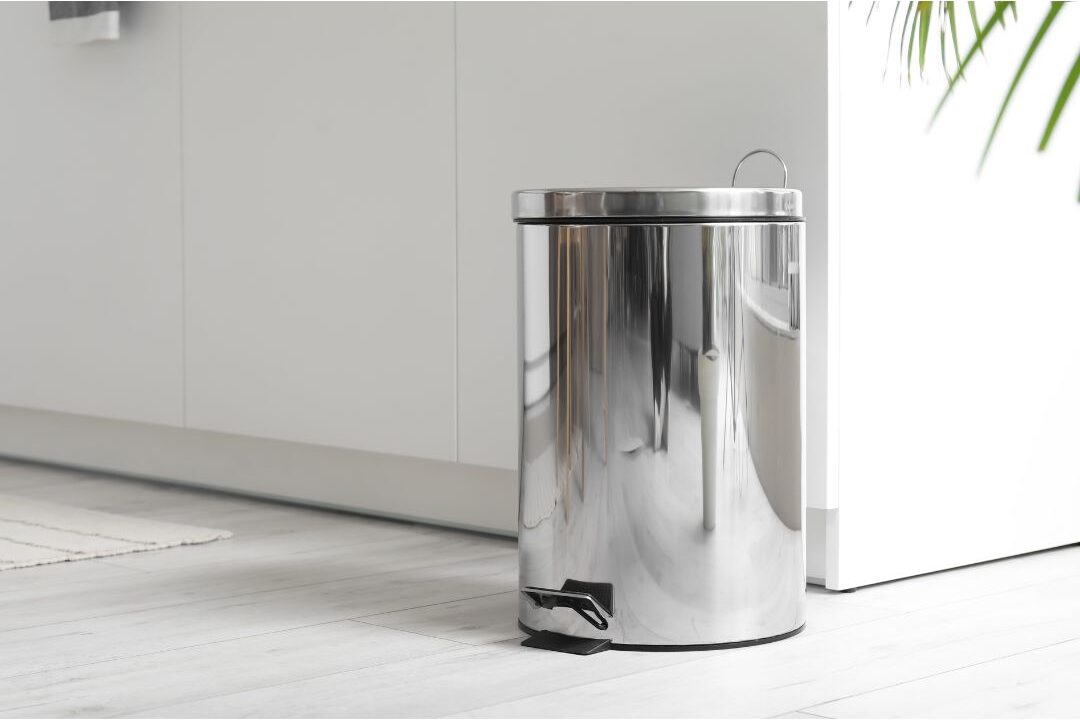 sleek covered stainless steel trash can keeping waste hidden from guests