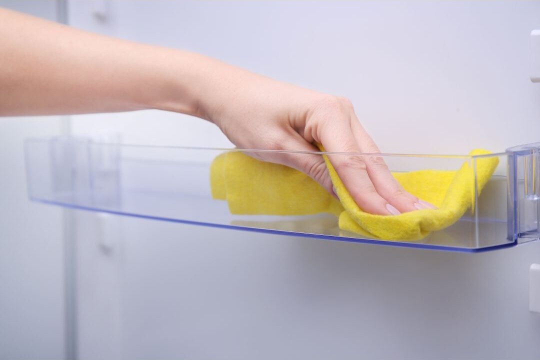wiping down the inside of the refrigerator monthly