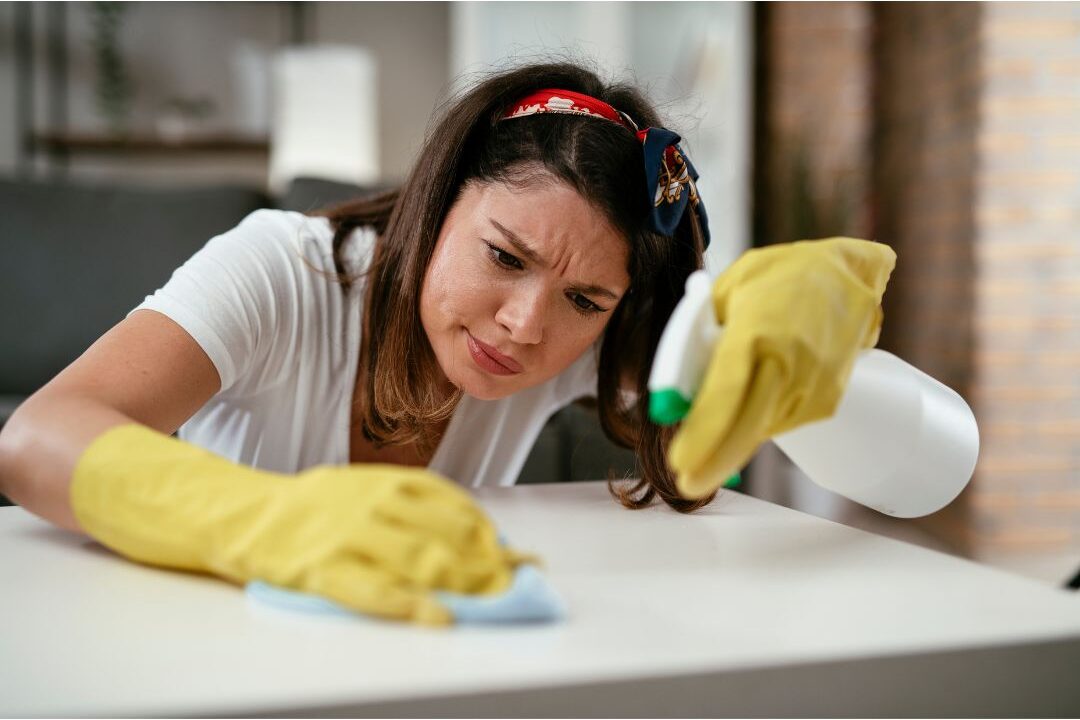woman cleaning her home but it still feels messy because of underlying problems