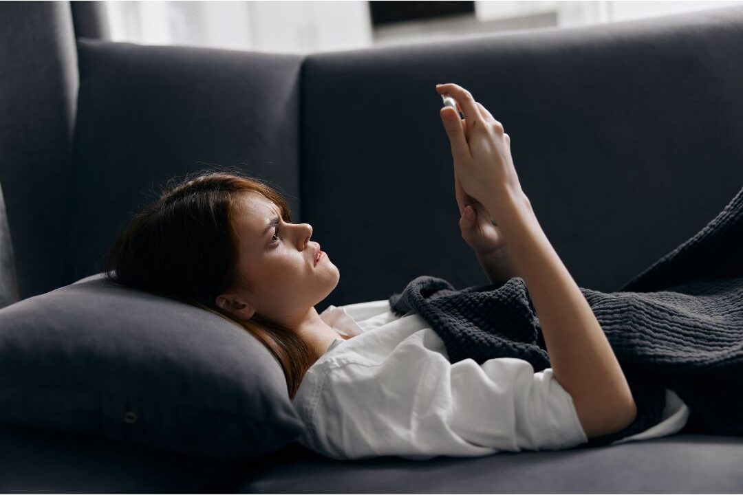 tired woman scrolling on her smartphone late at night suffering from digital fatigue