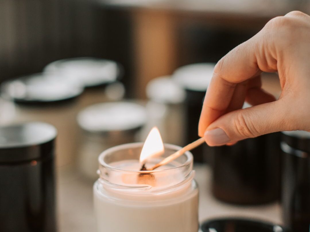 lighting a candle by the sink while washing dishes for everyday comfort