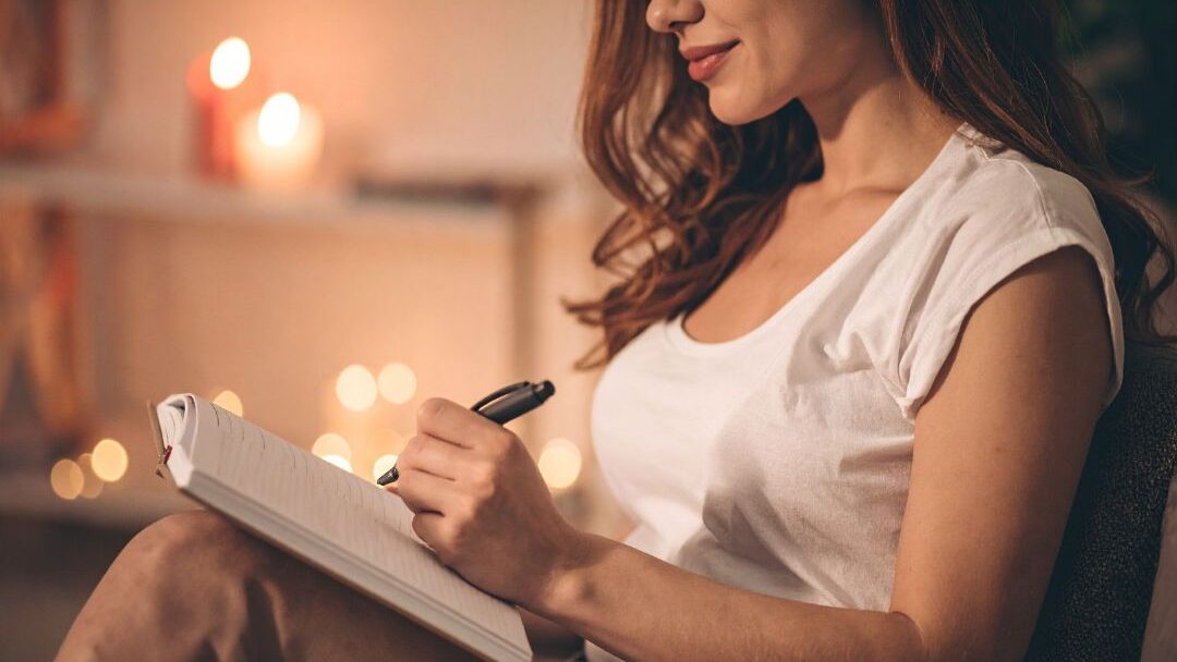 woman writing a dream list as a free creative self care habit