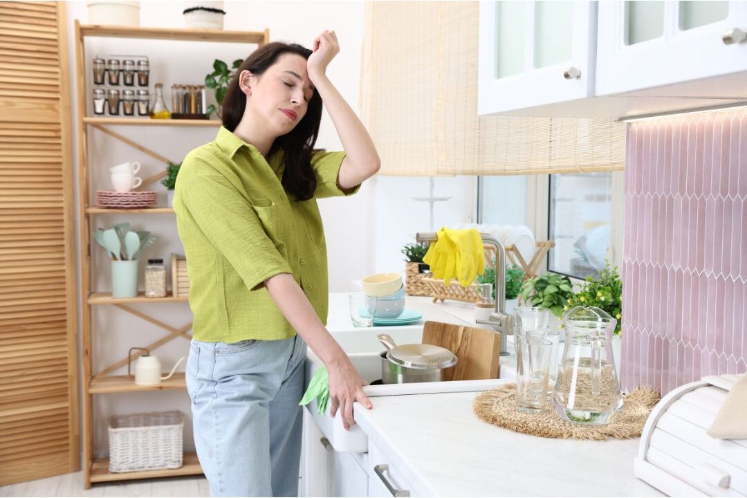 stressed mother feeling overwhelmed near a kitchen spill