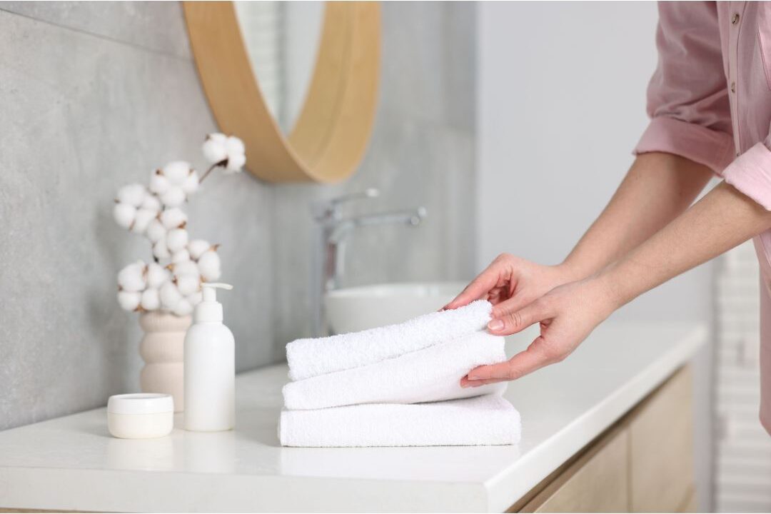freshly folded clean hand towels on a bathroom vanity