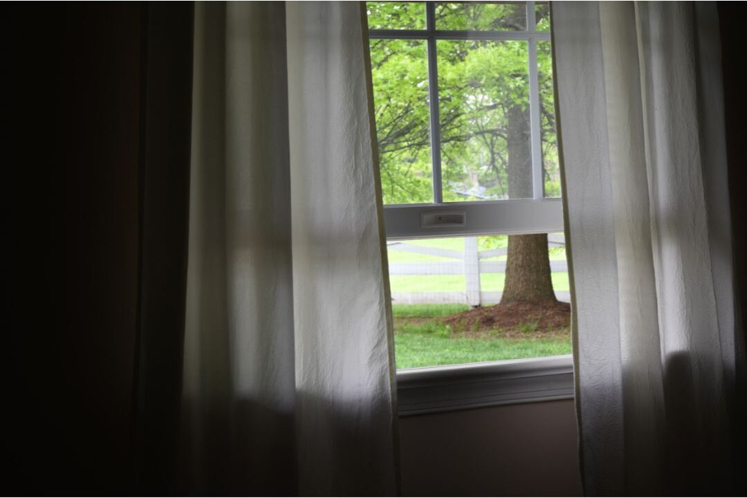 open window allowing fresh air into the living room for visiting guests