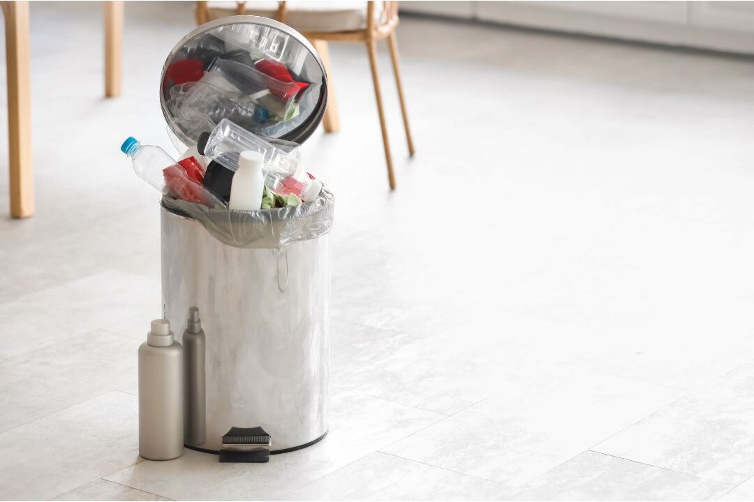 cleaning the kitchen bin to fix why the home always smells bad