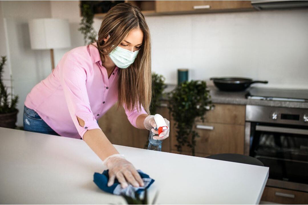 woman wiping kitchen counter realizing the real reason your kitchen never stays clean is lack of systems