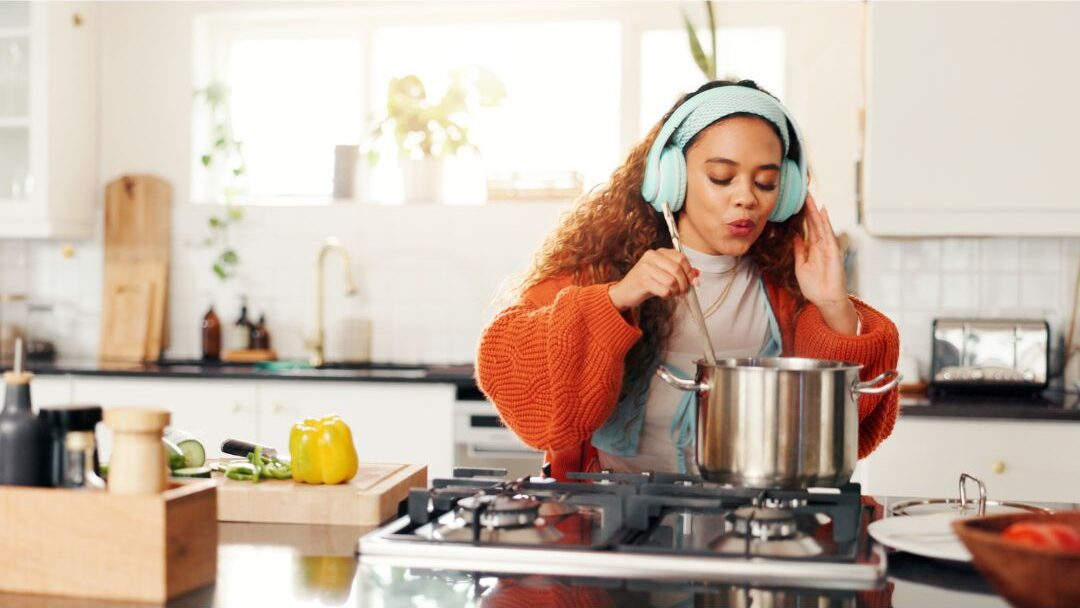 playing favorite music while cooking dinner for easy multi tasking wellness