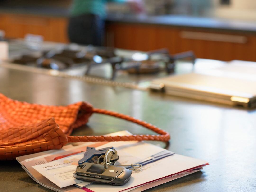 cluttered kitchen counter with mail and keys showing a key reason your kitchen never stays clean