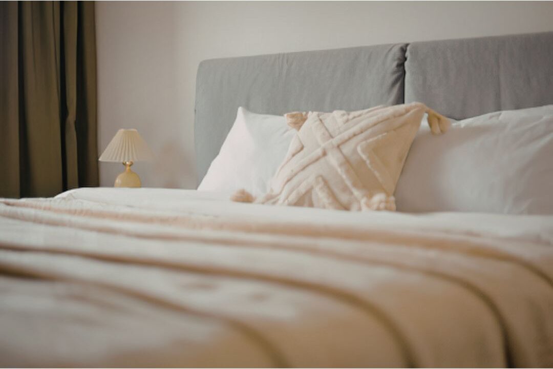a neatly made bed making a bedroom feel luxurious every single morning