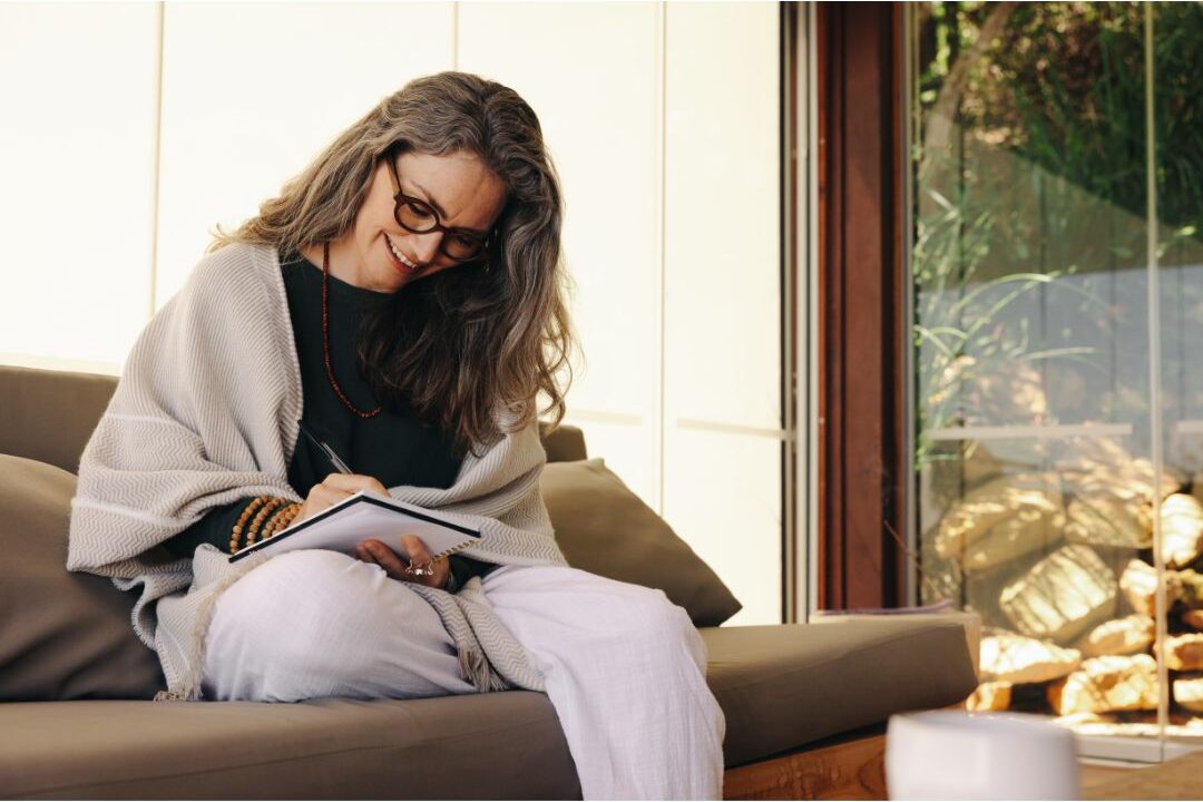 woman writing her thoughts in a journal demonstrating mental rest