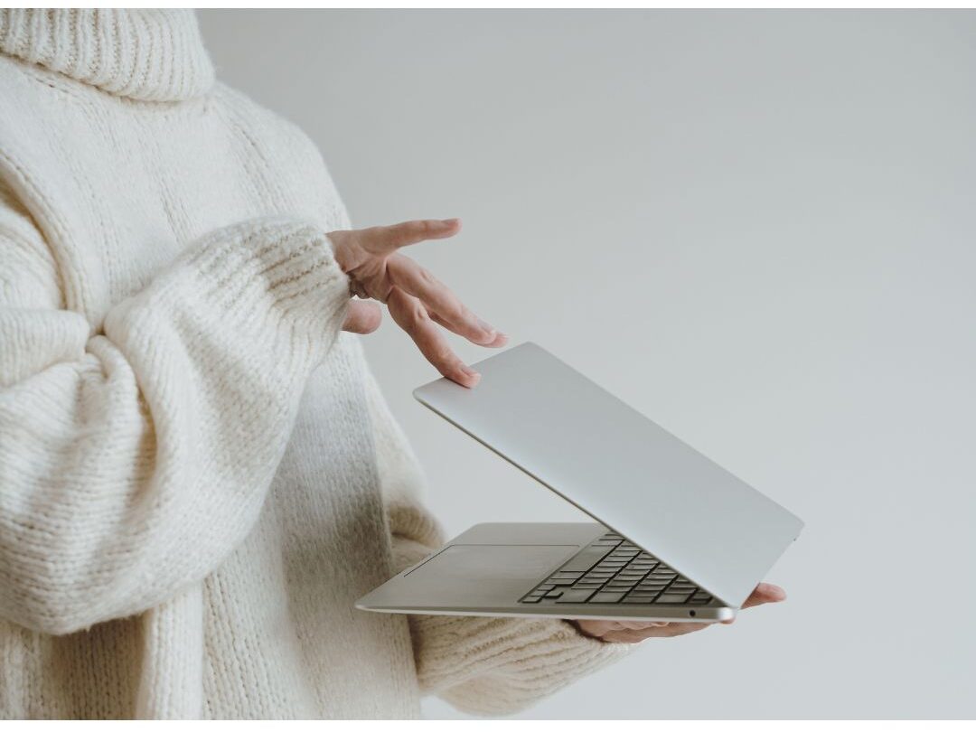 woman closing her laptop to protect her peace and stop comparing herself to other moms