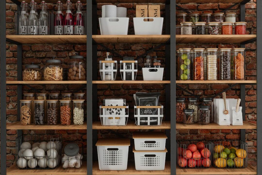 close up of an organized kitchen pantry with labeled glass jars and matching containers