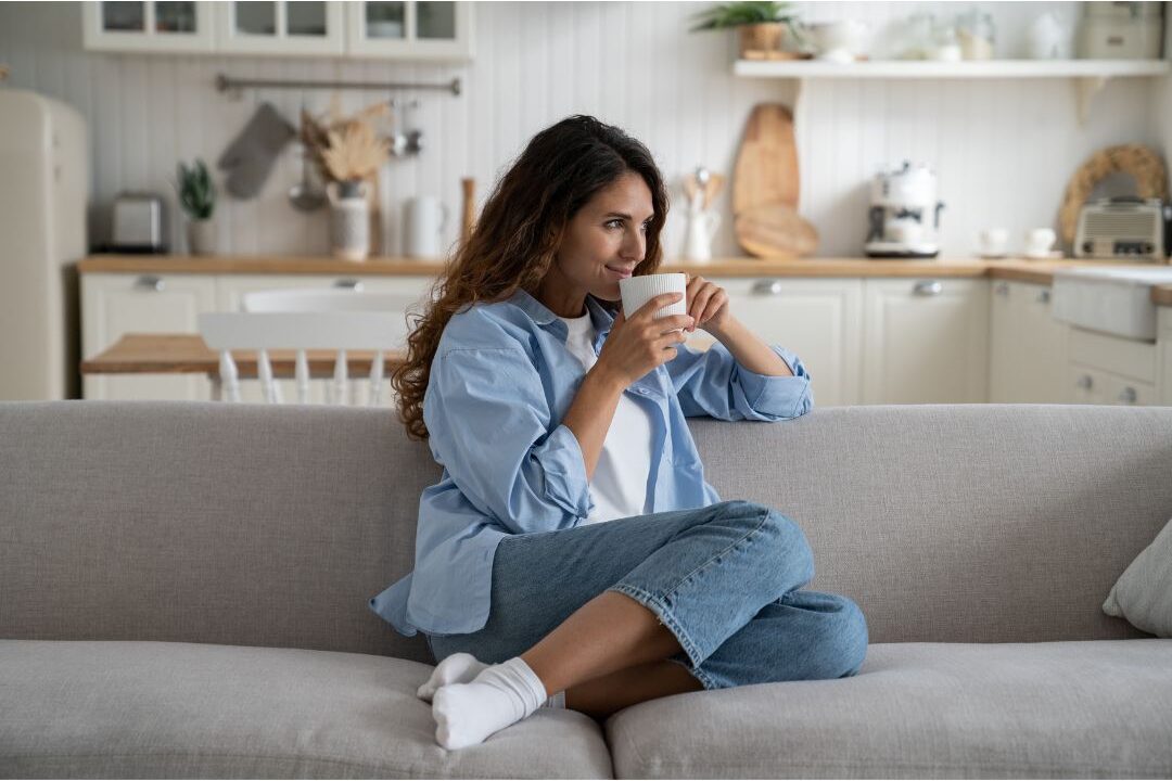 a mother holding coffee peacefully living an authentic grounded soft life