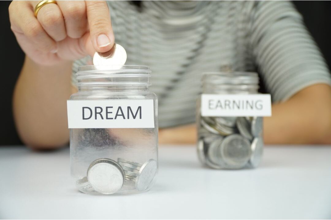 woman redirecting money saved from stopping unnecessary purchases toward a budget goal