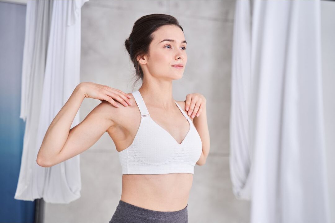completing a standing stretch as a self care idea for moms who never have time