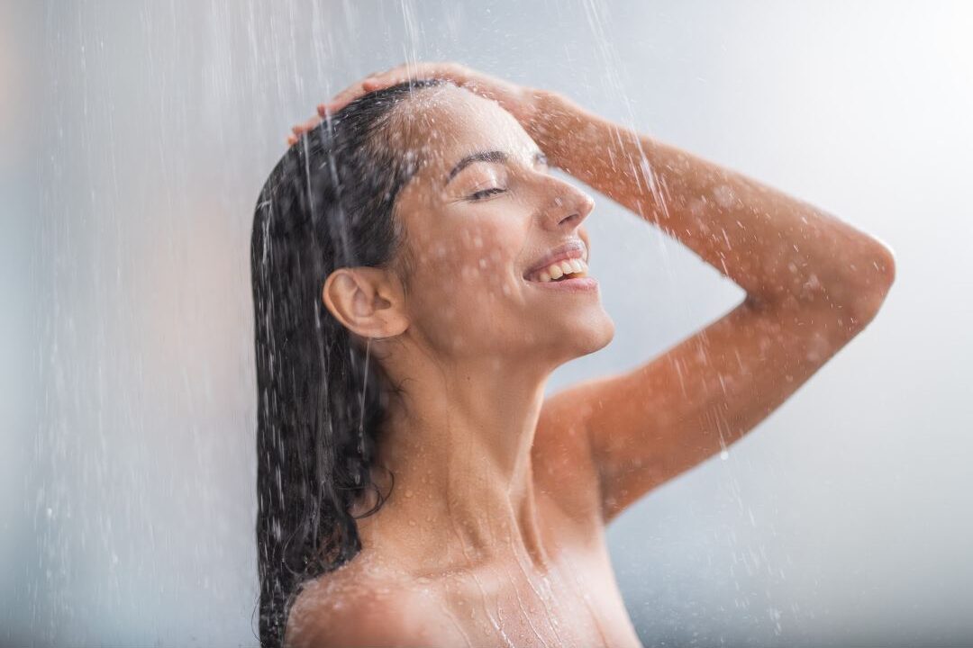 woman taking a longer shower as a free rest self care habit