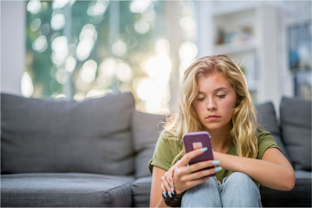 woman reviewing her subscriptions one of the things keeping her broke