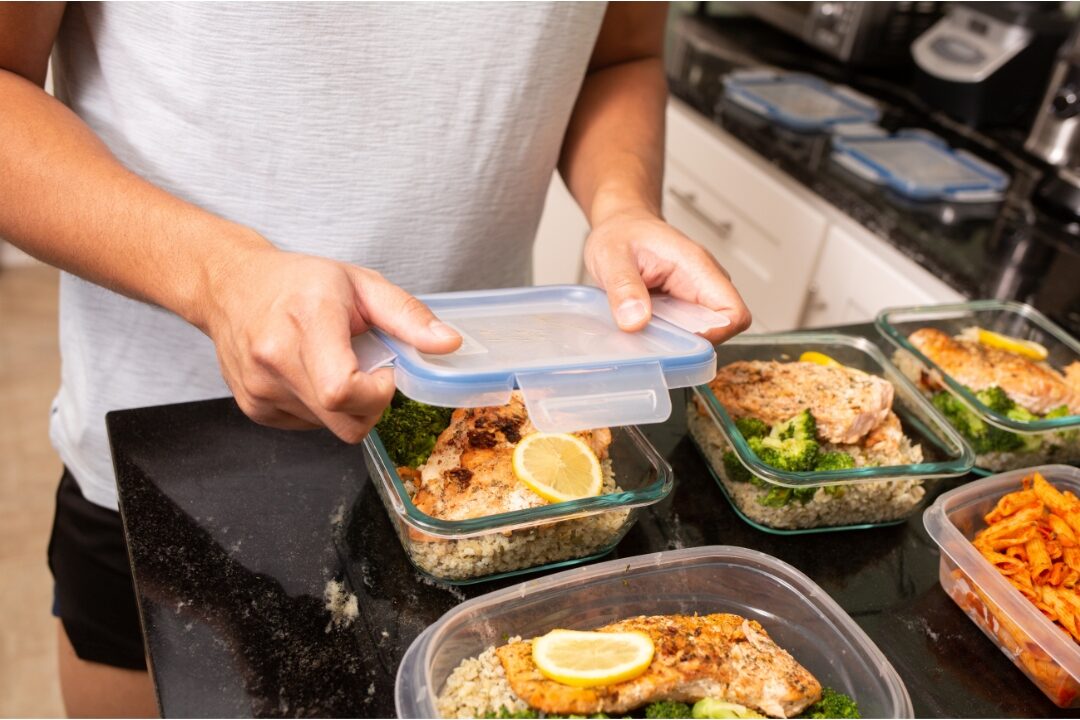 meal prepping healthy lunches into glass containers applying the systems that saved me 10 hours every week