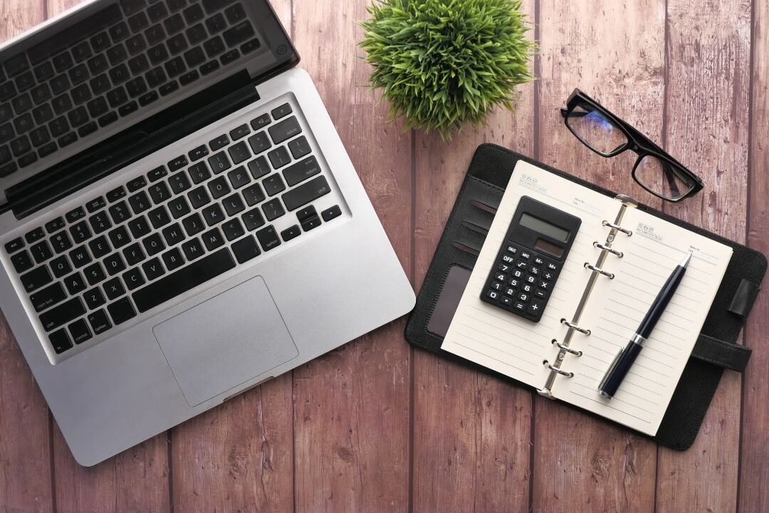 planner journal open on a table next to a computer keyboard showing why consistency matters