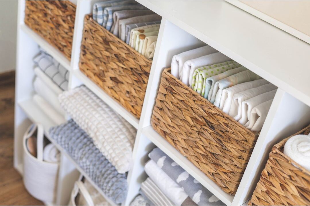 neatly organized linen closet with folded towels and woven baskets illustrating functional home systems