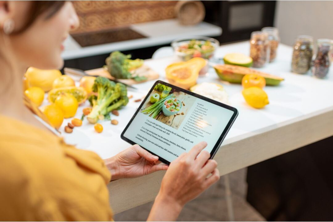 warm sunlit kitchen table with digital tablet and notepad showing calm time blocking structure