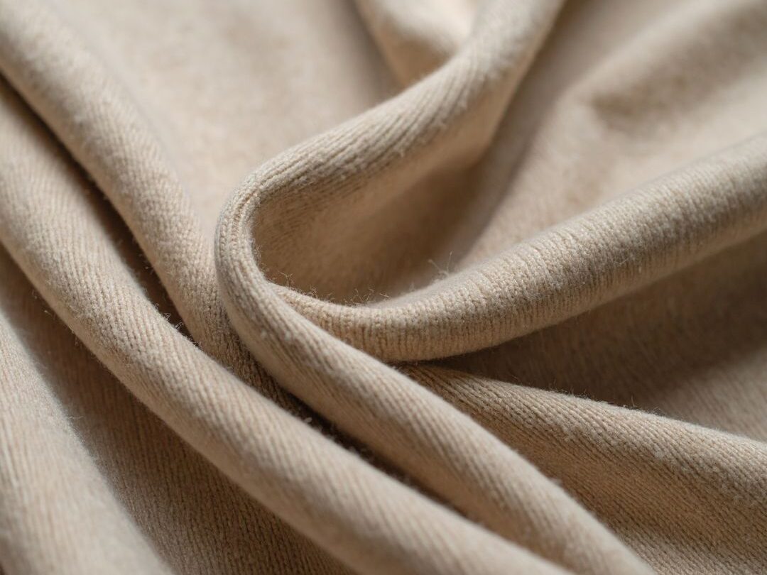 close up of high quality cream cashmere and linen fabric texture showing natural textile