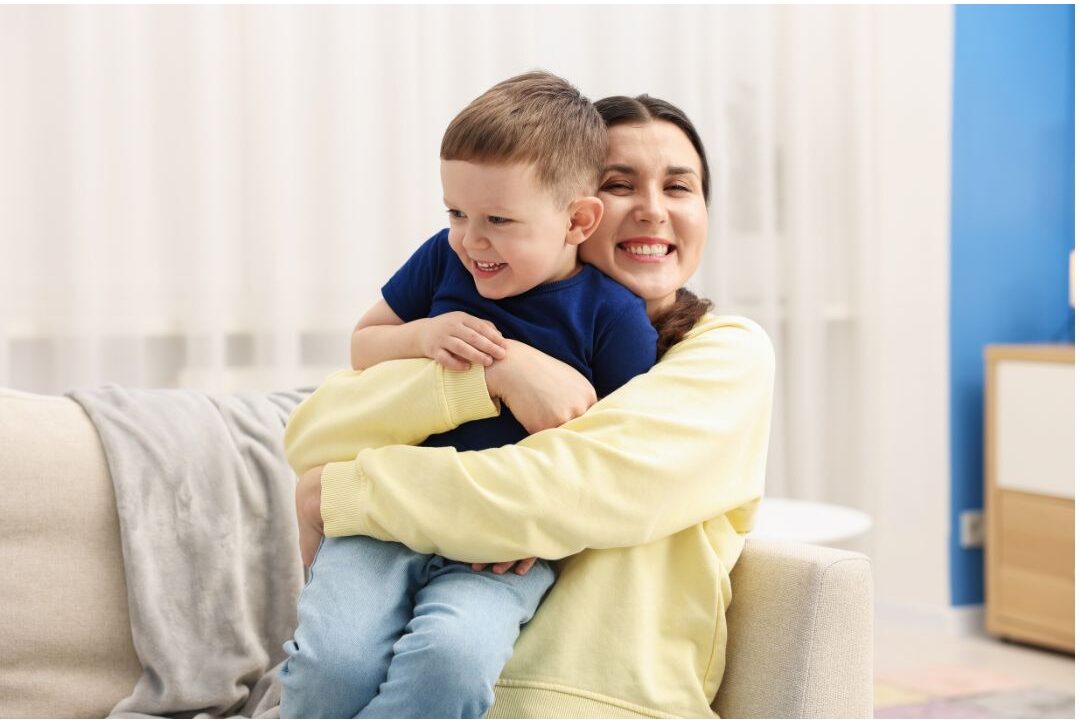 mother hugging her young child warmly in cozy room showing emotional presence