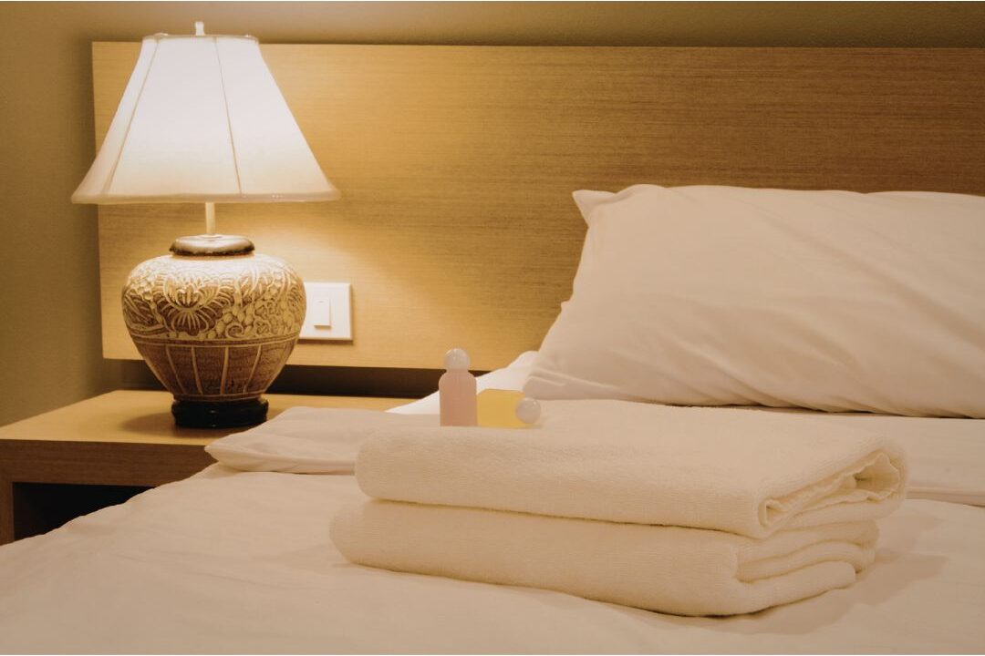 clean organized bedroom nightstand under soft warm lighting