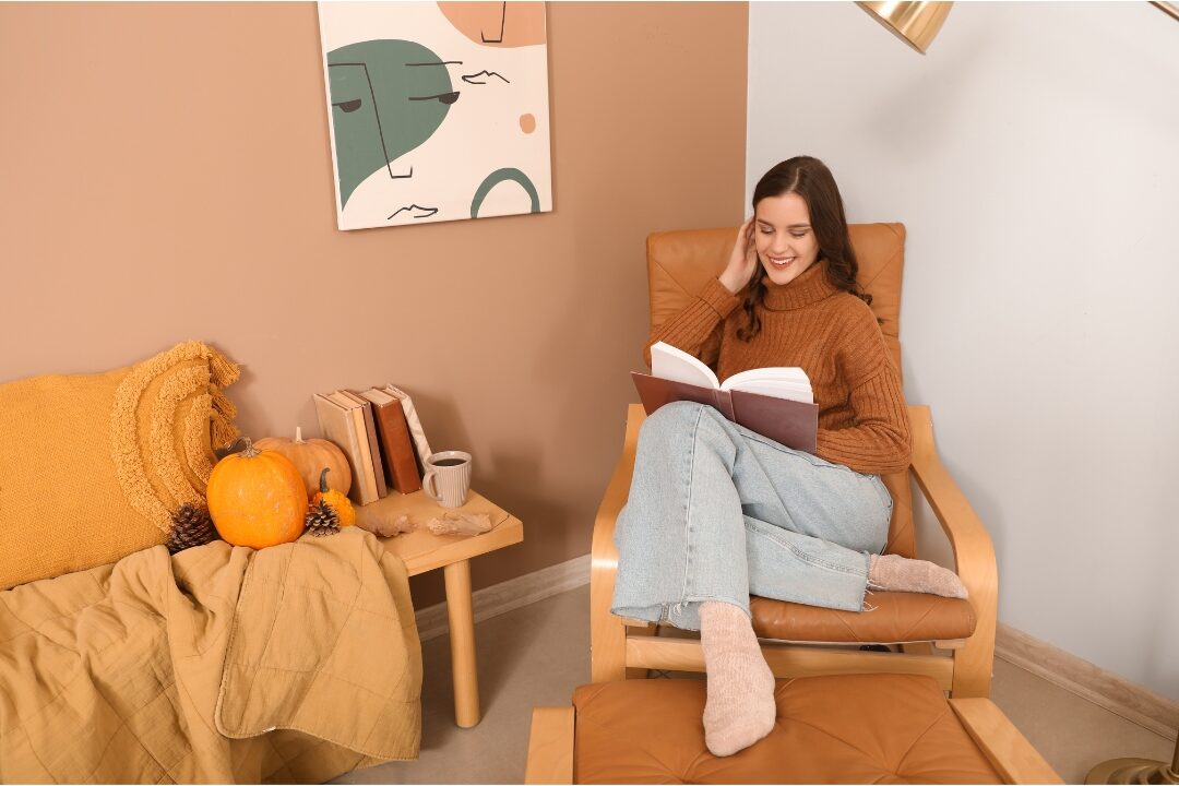 woman reading book quietly on comfortable armchair enjoying peaceful quiet home