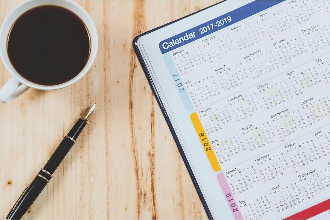 minimalist paper planner on wooden table with clean coffee cup showing organized daily structure