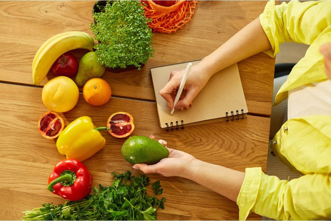 open meal planner notebook with fresh ingredients on kitchen counter eliminating daily decision fatigue