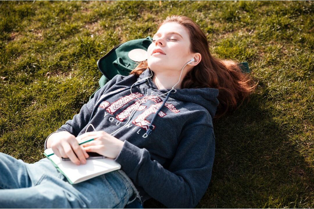 woman closing a notebook with a relaxed peaceful expression