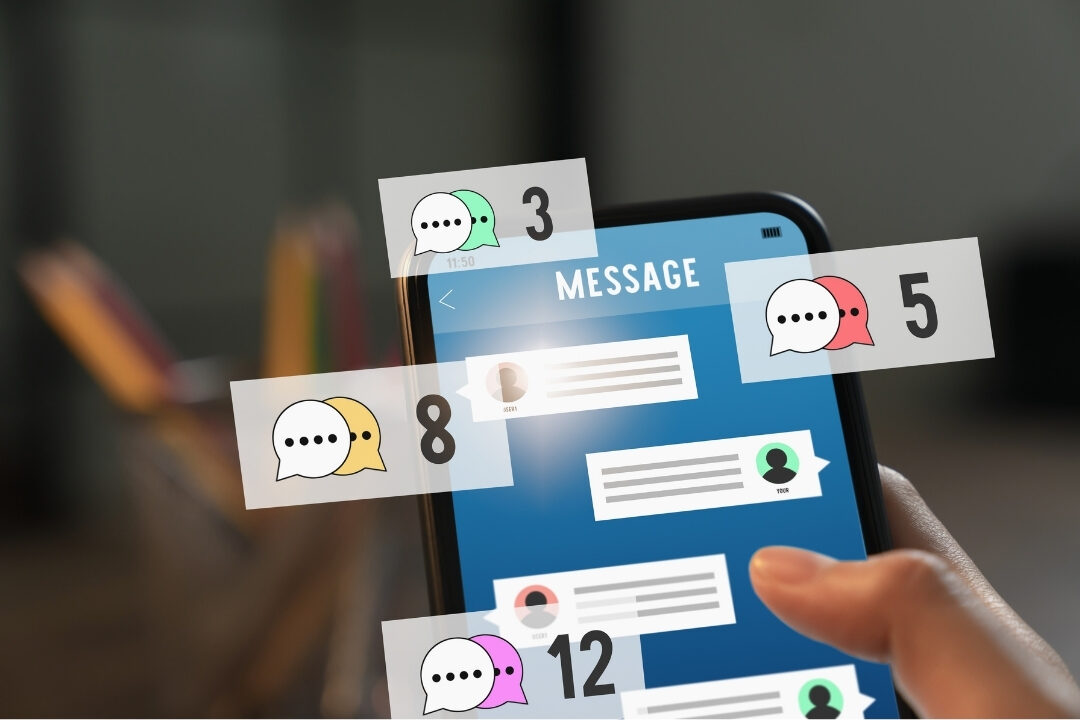close up of smartphone screen with multiple notification alerts beside desk causing digital distraction