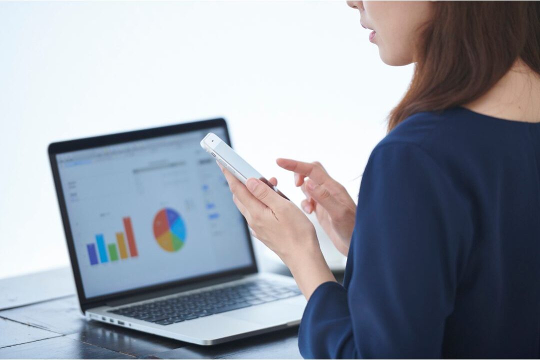 woman analyzing digital stats and charts on a screen to build an owned audience list