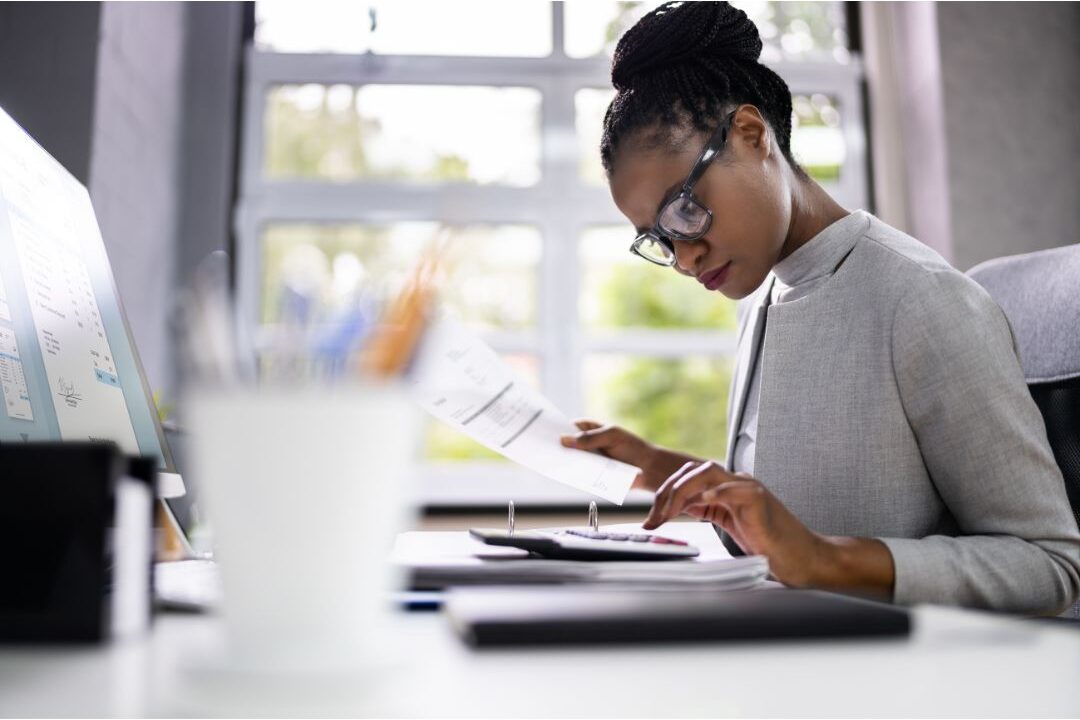 woman reviewing her personal emergency savings account on a tablet peacefully