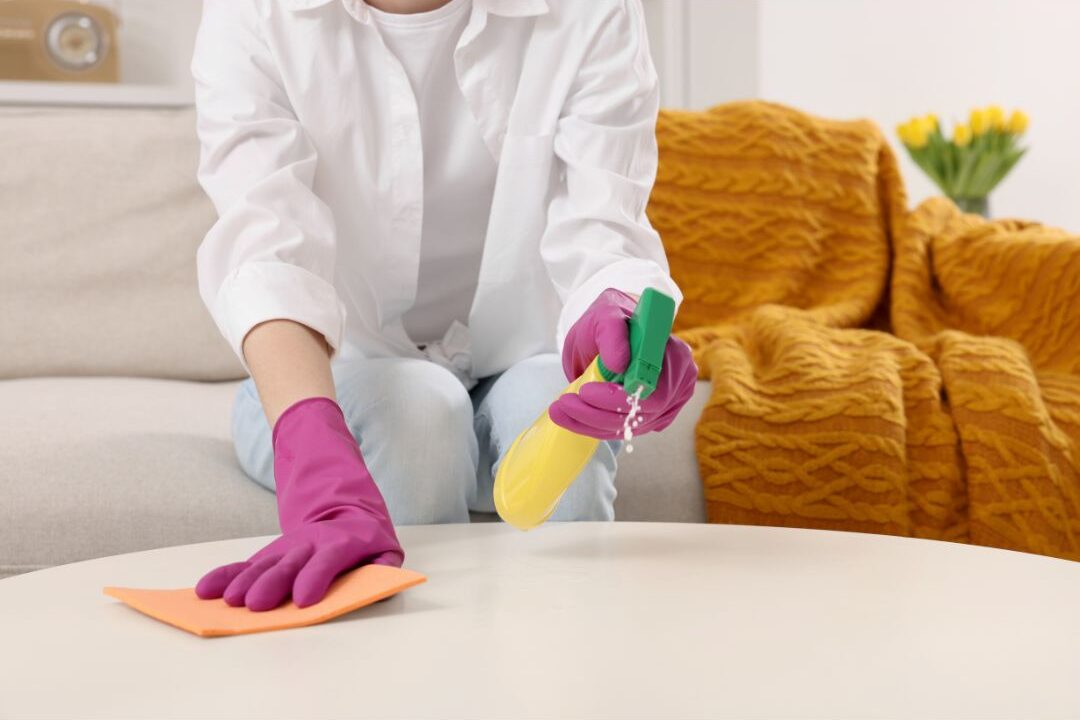 woman tidying up living room cushions and wooden coffee table breaking the endless pick up loop
