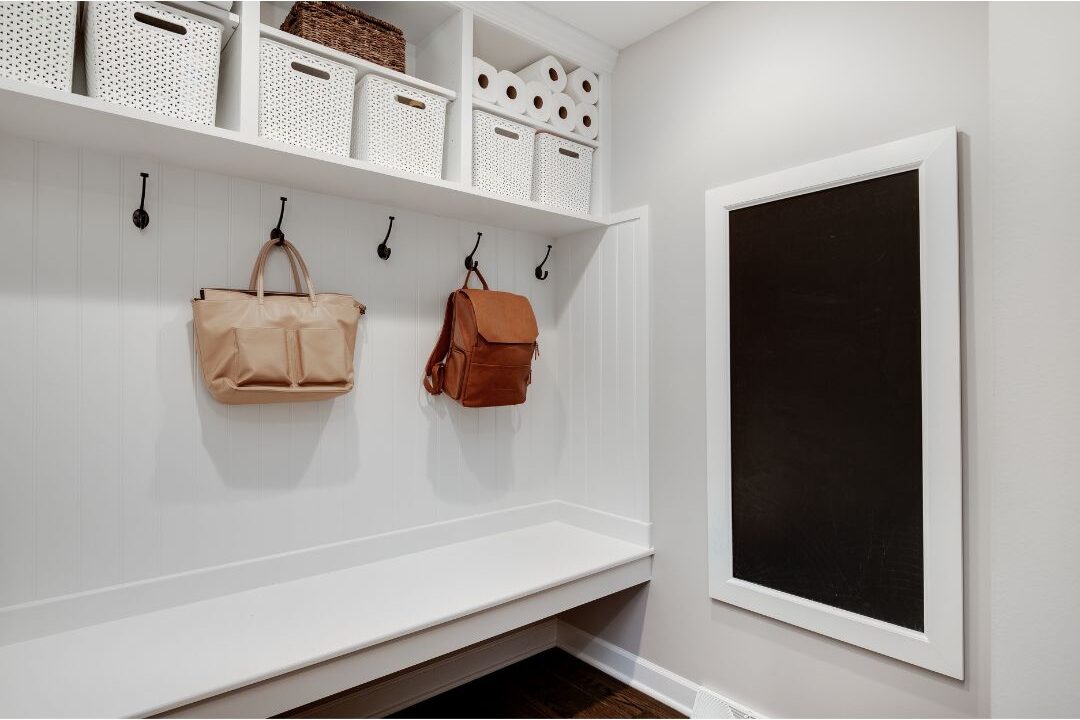 clean mudroom bench with coat hooks and shoe storage showcasing entryway landing pads