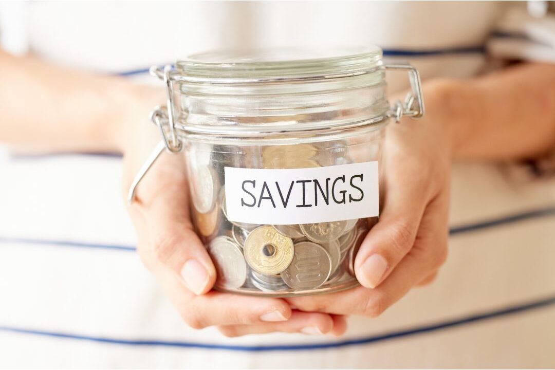 glass jar labeled savings with coins and a small plant showing things poor families buy that wealthy families skip fixes