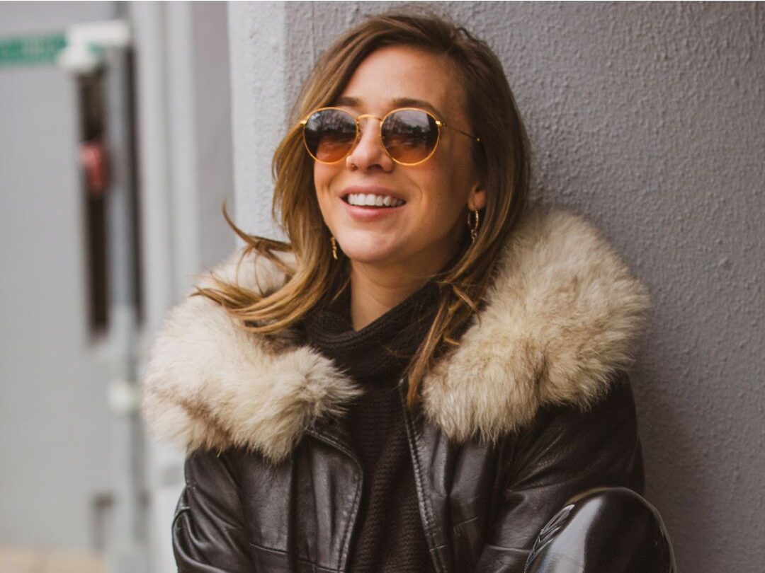 chic woman wearing structured tan leather jacket outdoors showing quality leather