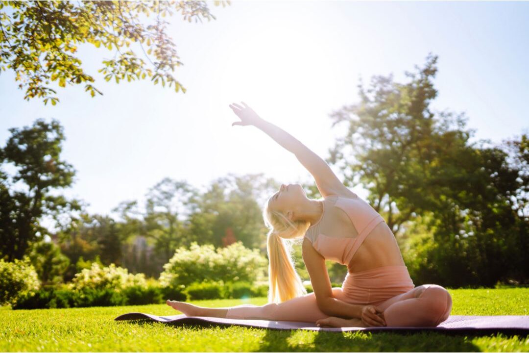 woman stretching peacefully outdoors in the morning for physical recovery