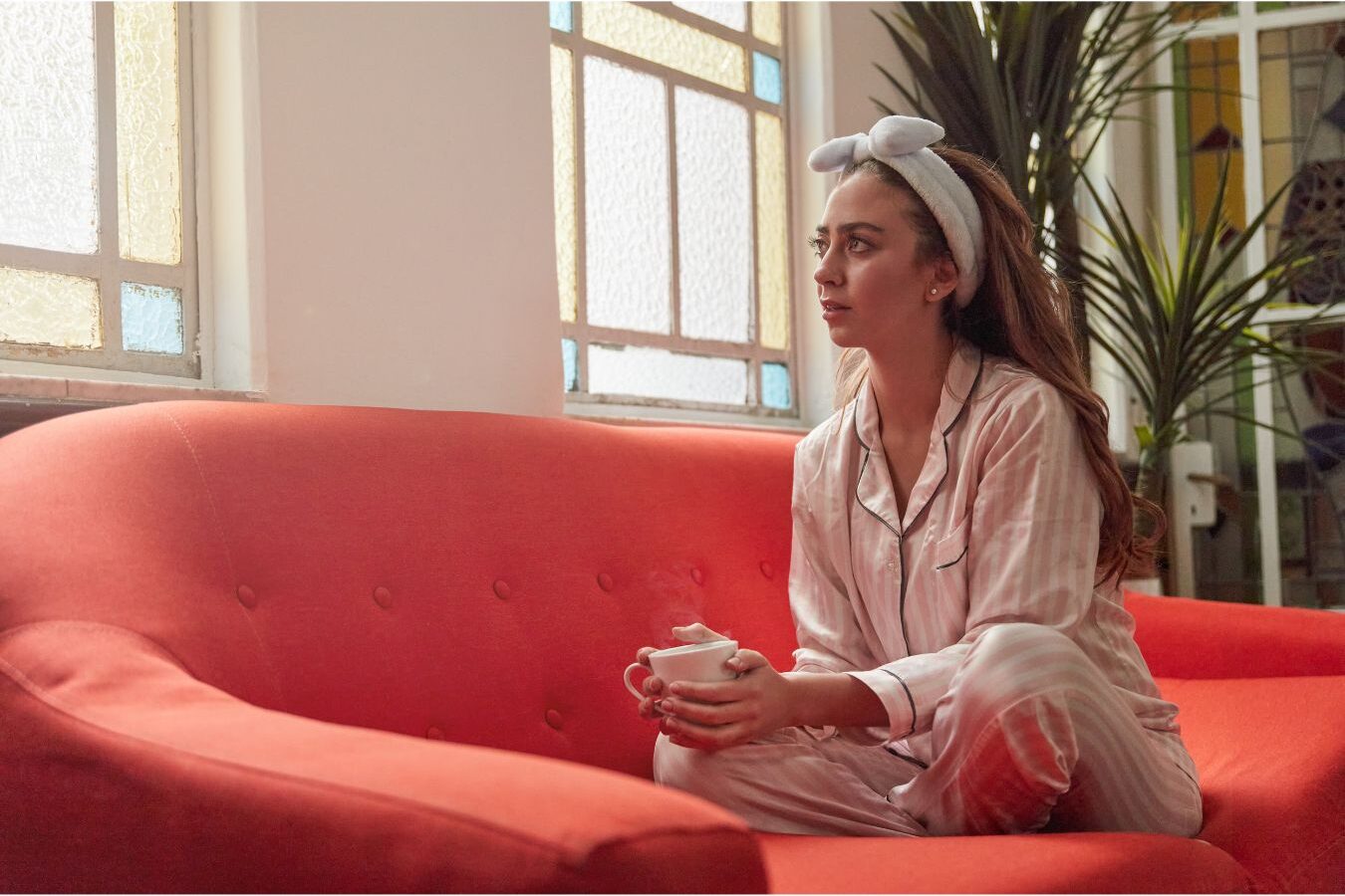 peaceful woman holding warm mug looking out window discovering how to get more done before breakfast