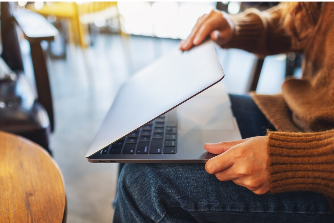 peaceful woman closing laptop at cozy clean desk learning how to work from home without feeling like you're working all day